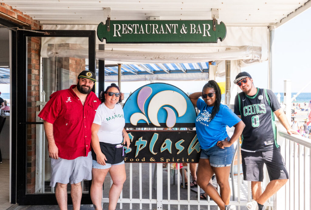 splash restaurant group taking photo by sign